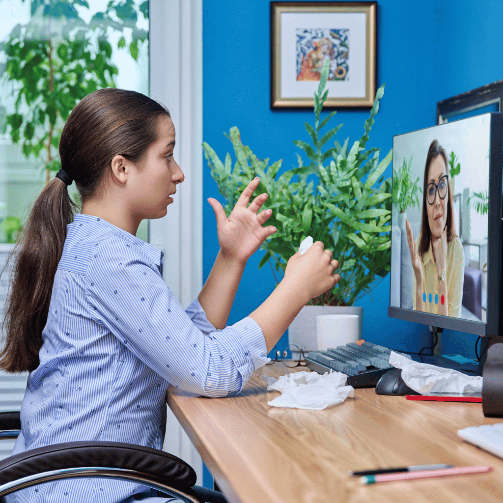 Person having an emotional video call at a desk